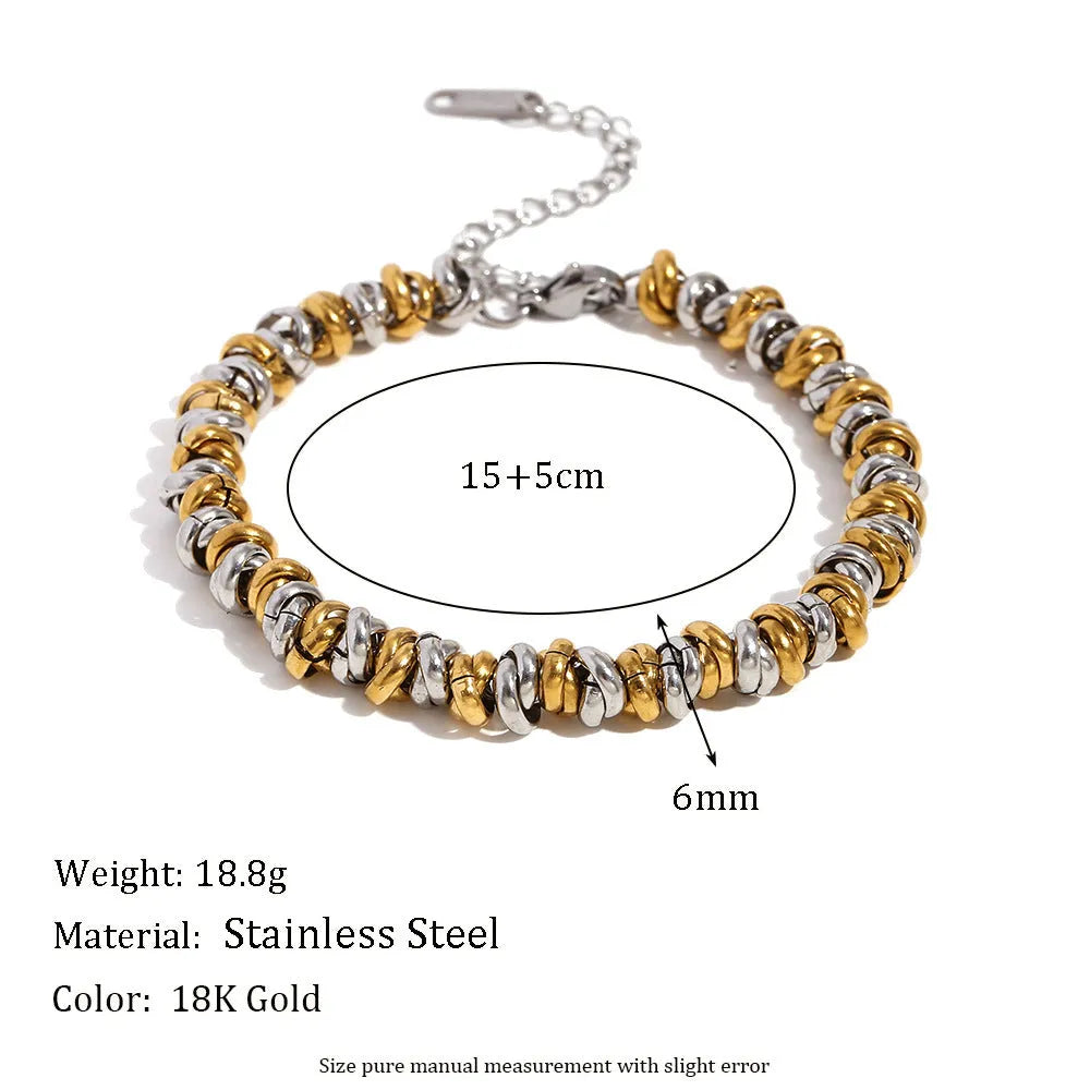 Gold tone geometric jewellery set including earrings, bracelet and necklace with round ring design elements