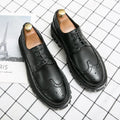 Men's black and brown brogue Oxford shoes with round toe and decorative detailing for business formal wear