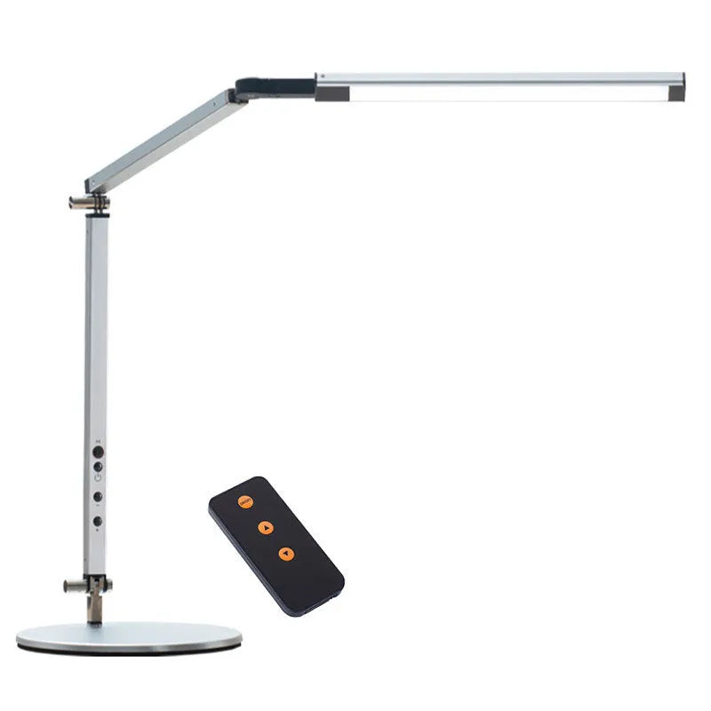 Black adjustable clip-on desk lamp with flexible arm and remote control on a wooden desk