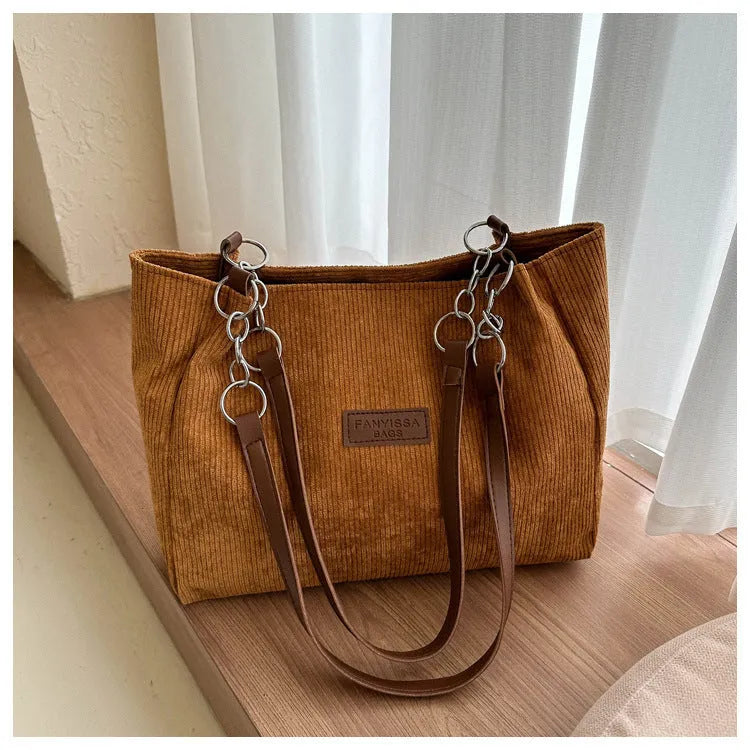 Corduroy one-shoulder tote handbag in a horizontal square shape, shown in brown colour.