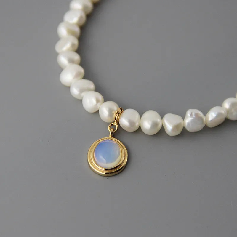 White geometric pendant on an adjustable sterling silver necklace chain.