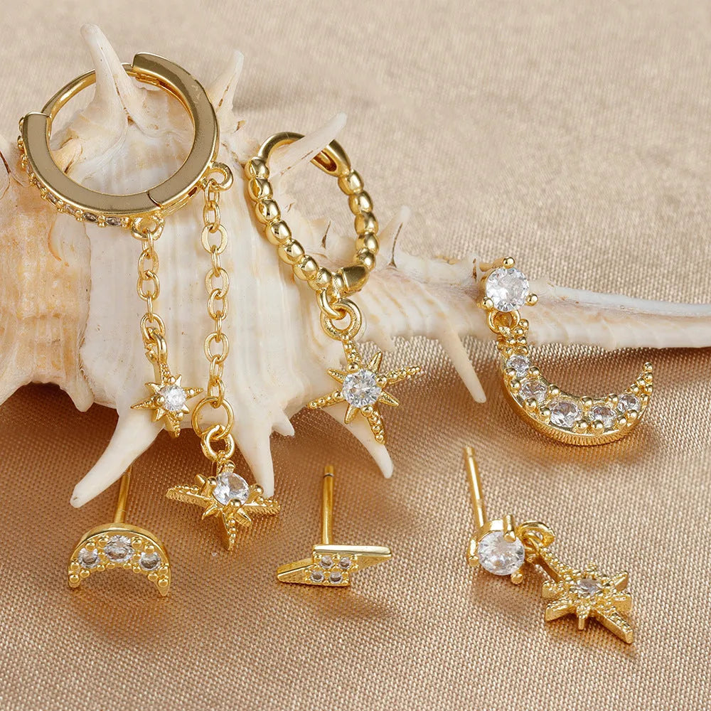 Six pairs of gold electroplated chain tassel earrings with zircon studs on display