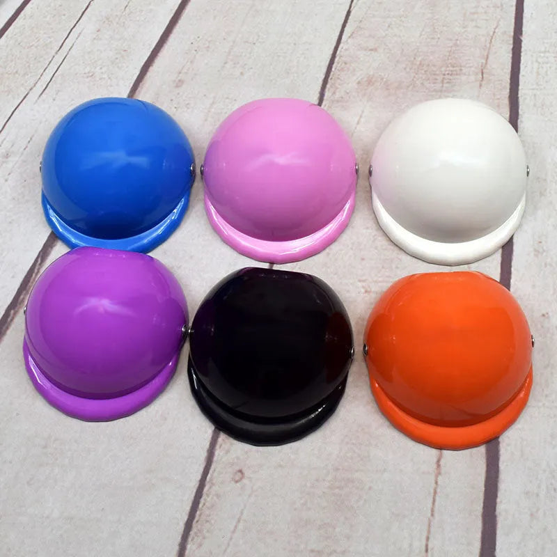 Solid colour plastic dog motorcycle helmet cap in Japanese South Korea style on a pink background.