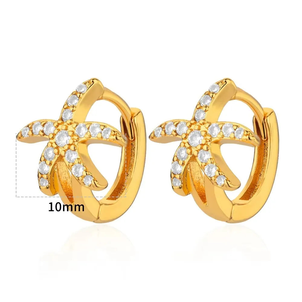 Geometric butterfly-shaped earrings with heart, bow, and star details in copper with a diamond-cut finish.
