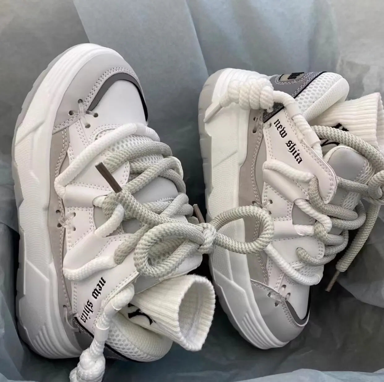 Women's grey retro chunky platform sneakers with thick rubber sole and lace-up front.