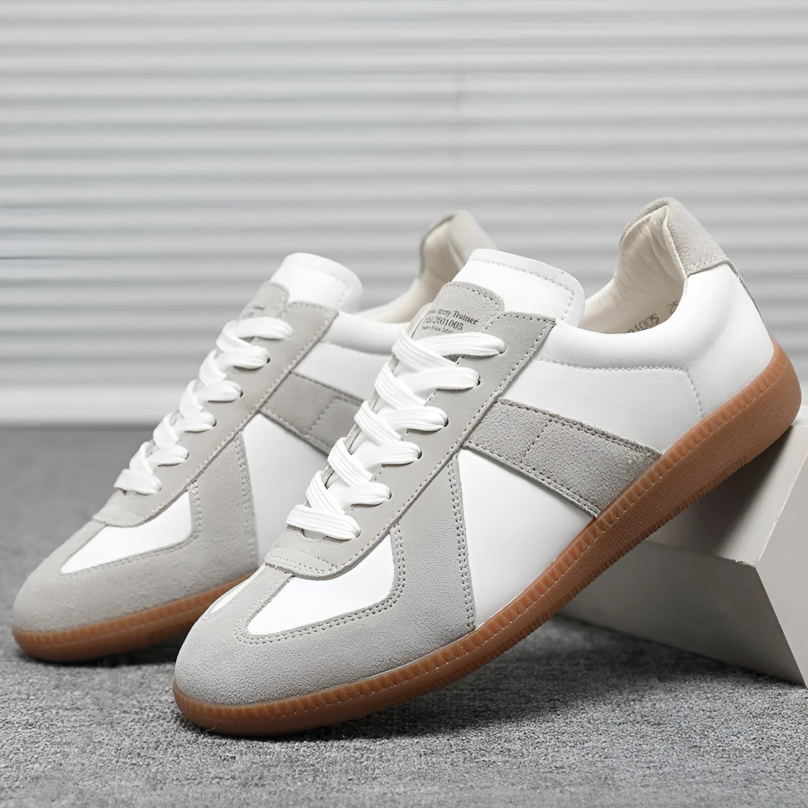 White retro unisex board sneakers with lace-up front and round toe on a rubber sole.