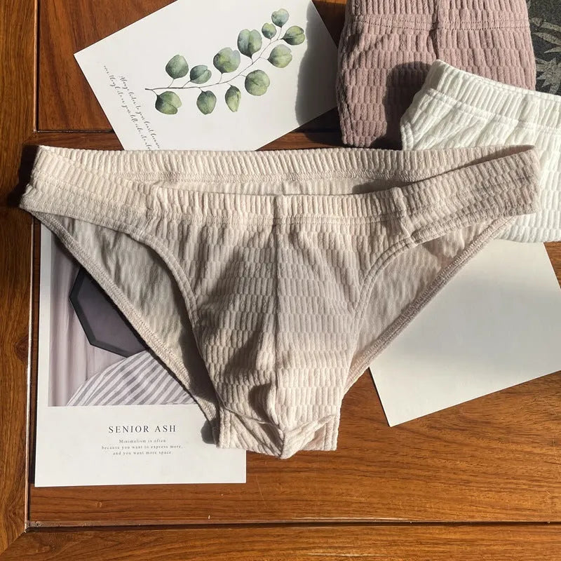 Men's solid colour cotton briefs with a mid waist and triangle design.