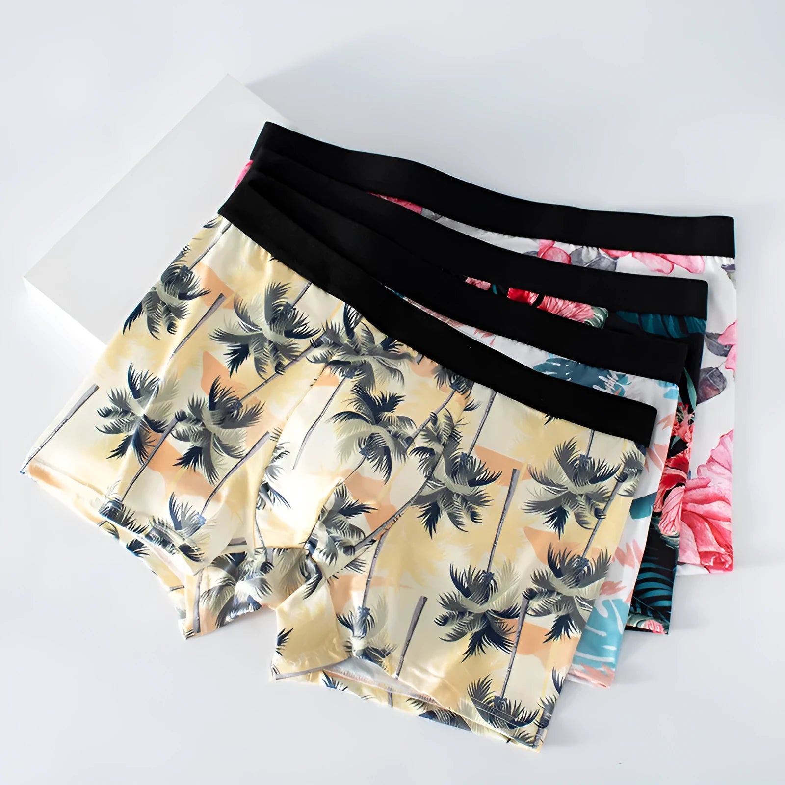 Men's light grey printed polyester underwear laid flat, showing mid waist design.