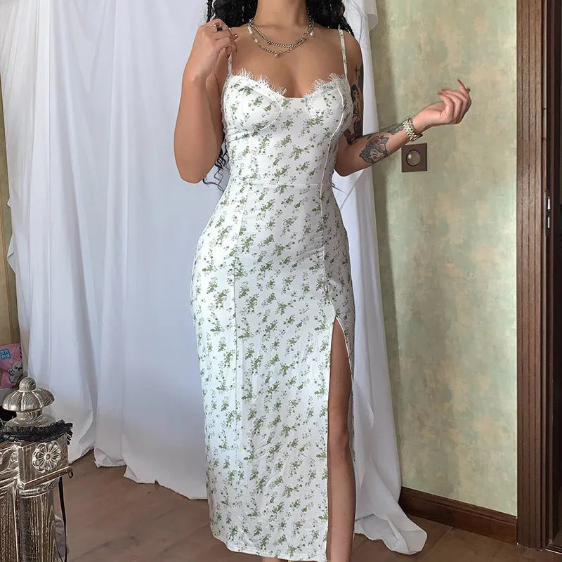 Blue lace flowers print long dress with spaghetti straps and a high leg slit on a mannequin.