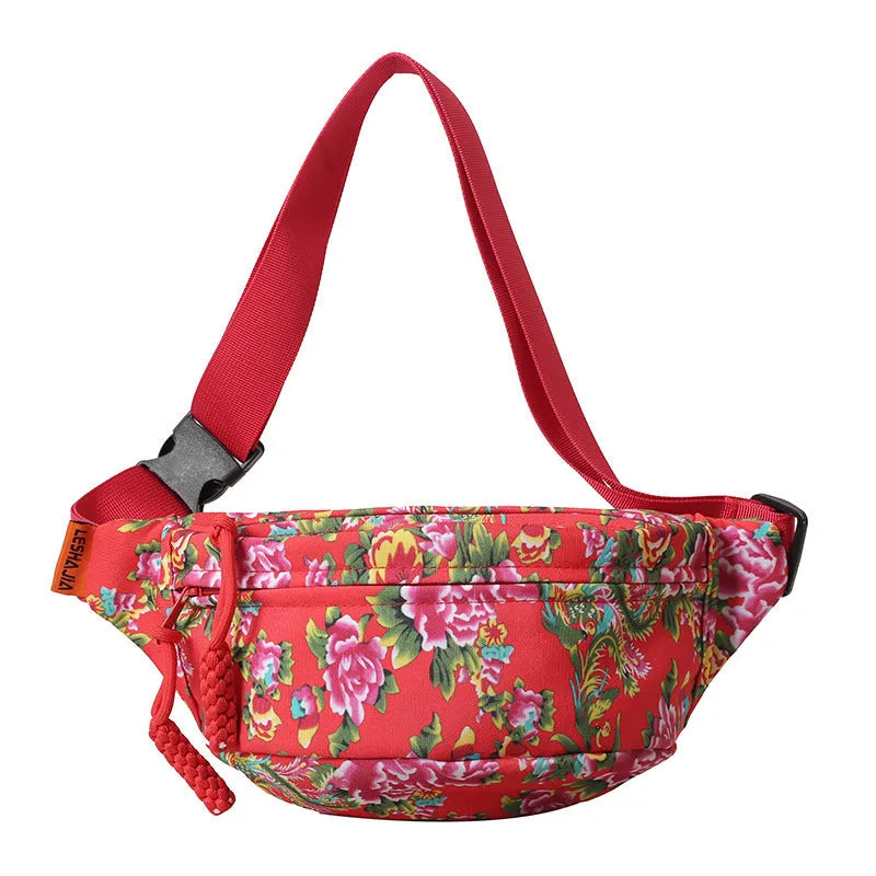 Women's black waist bag with large red flower design and western stitching details.