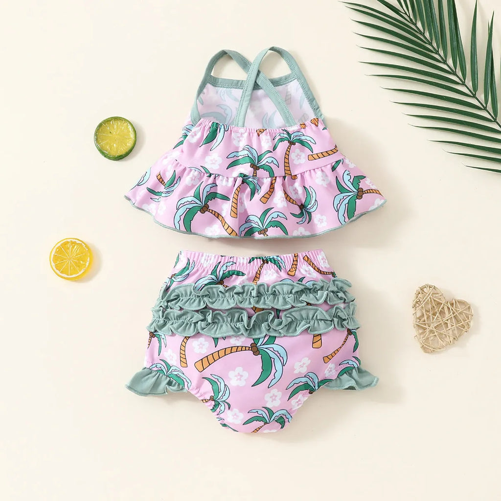 A white kids' two-piece swimsuit set consisting of a shirt and shorts, laid flat.