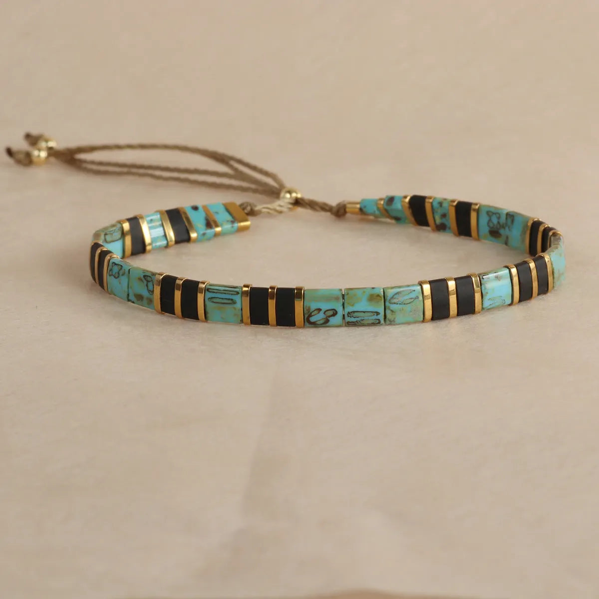 Geometric glass pull bead bracelet in five colour options on wrist