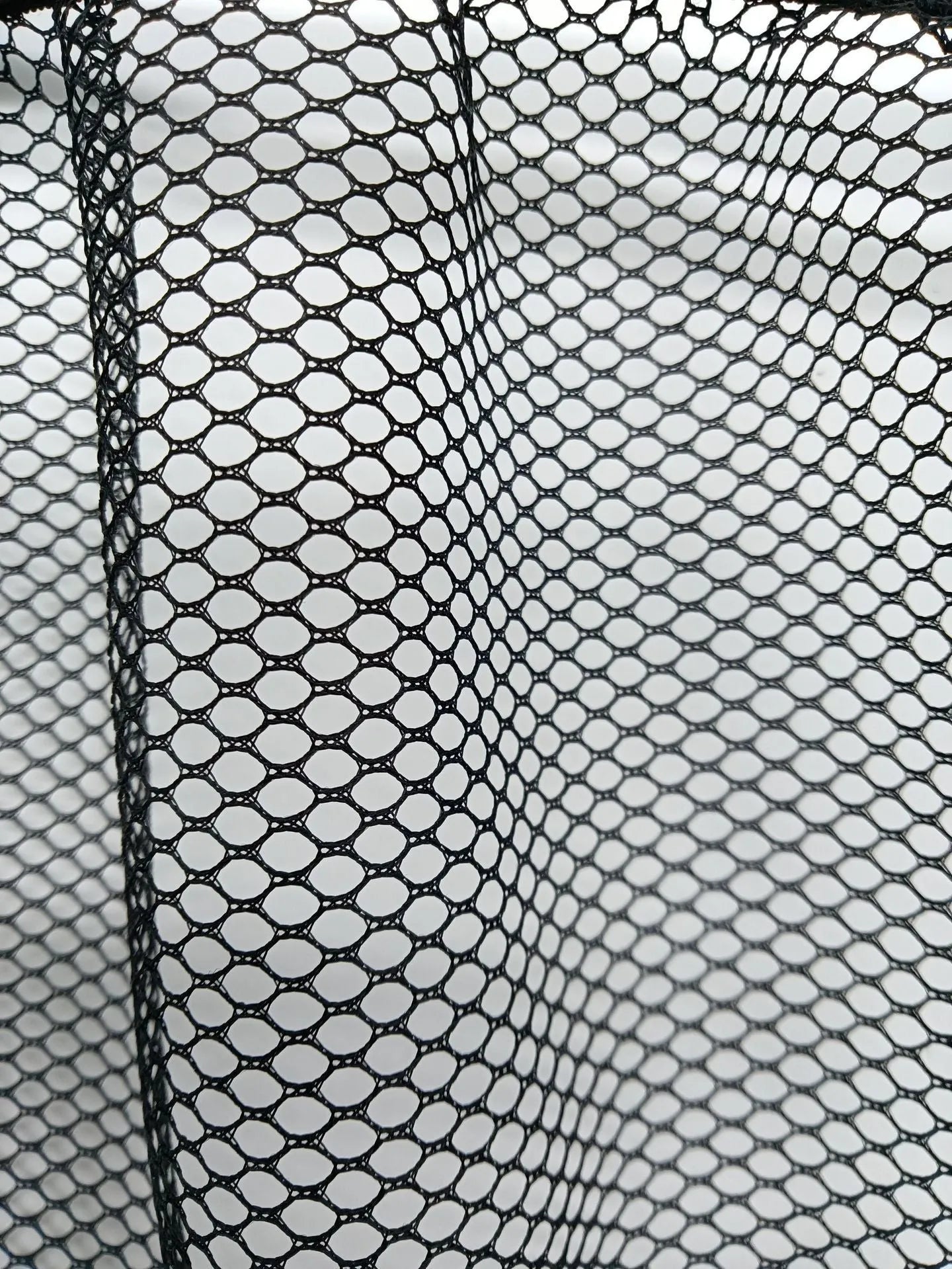 Elasticated polyester car boot storage net shown holding shopping bags, available in 20x35cm and 20x45cm sizes.