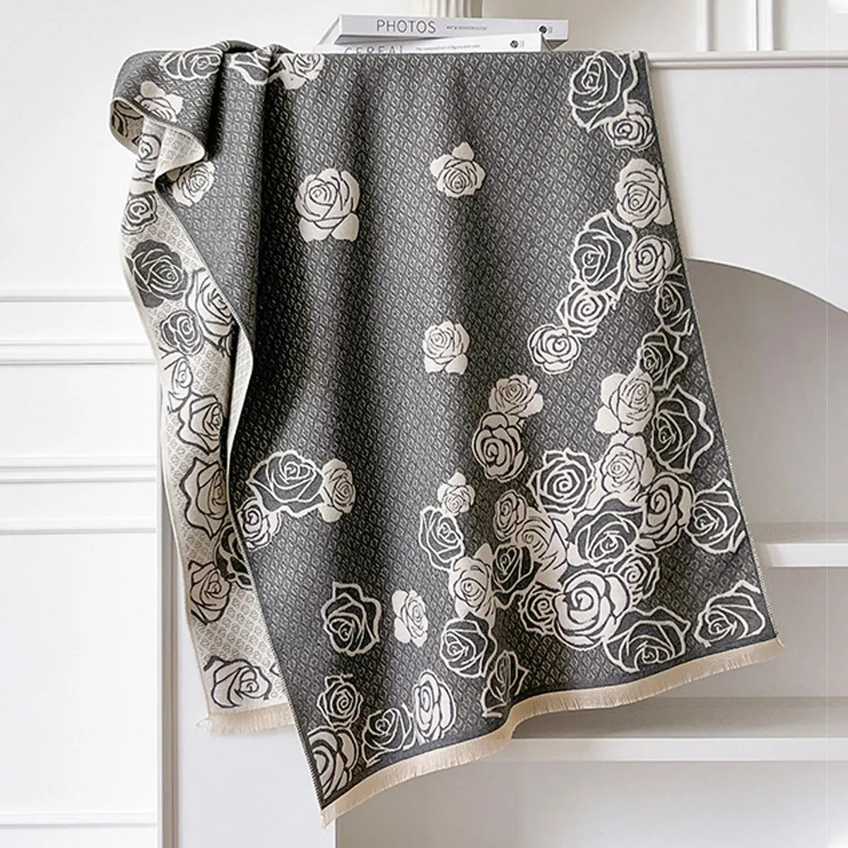 Grey imitation cashmere winter scarf with tassels laid flat, showing its long rectangular shape.