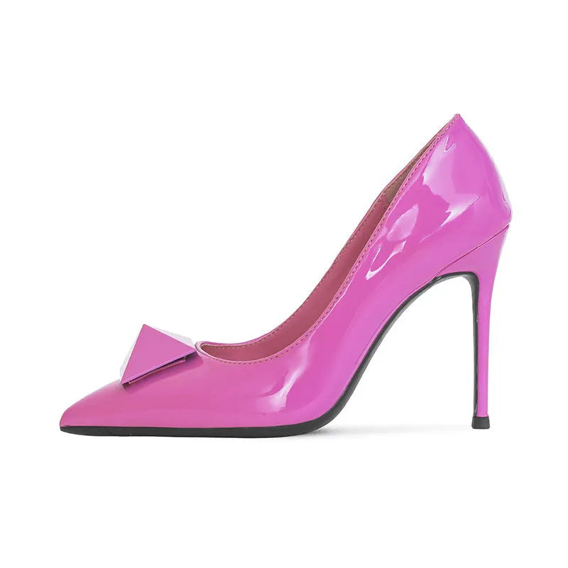 Pink patent leather women's pointed toe stiletto high heels with a rivet buckle.
