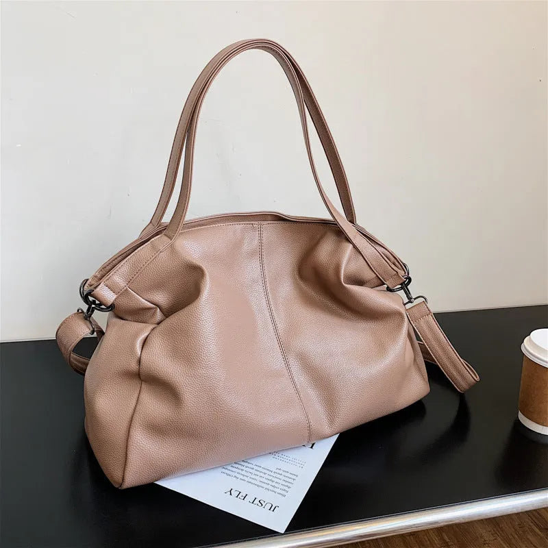 Large soft PU leather messenger bag with adjustable strap in black, shown open with internal pockets.