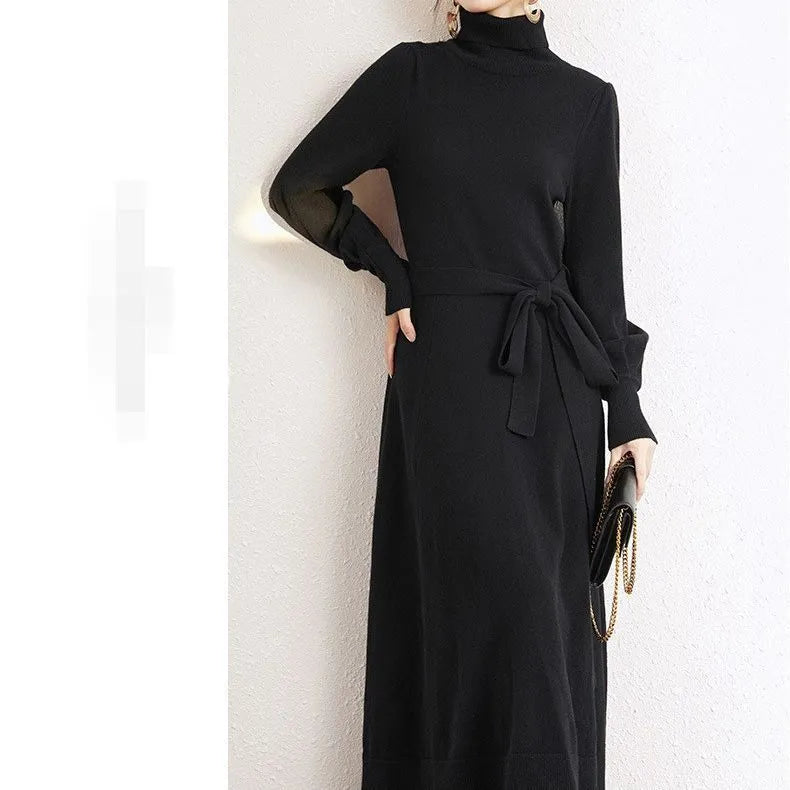 Women's knitted turtleneck dress with long sleeves, elastic waist, and a loose A-line skirt in a solid colour.