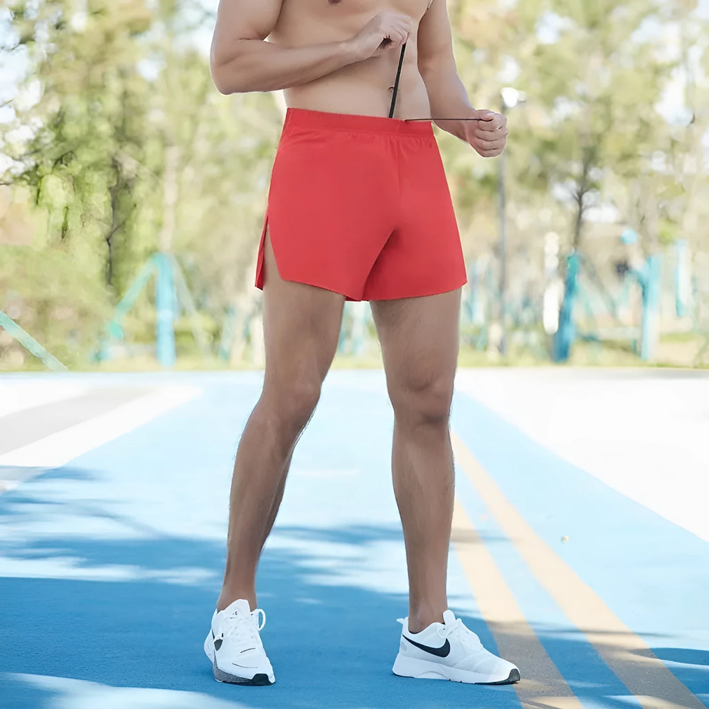 Men's loose-fitting off-road running shorts in black, shown for marathon and cross-country training