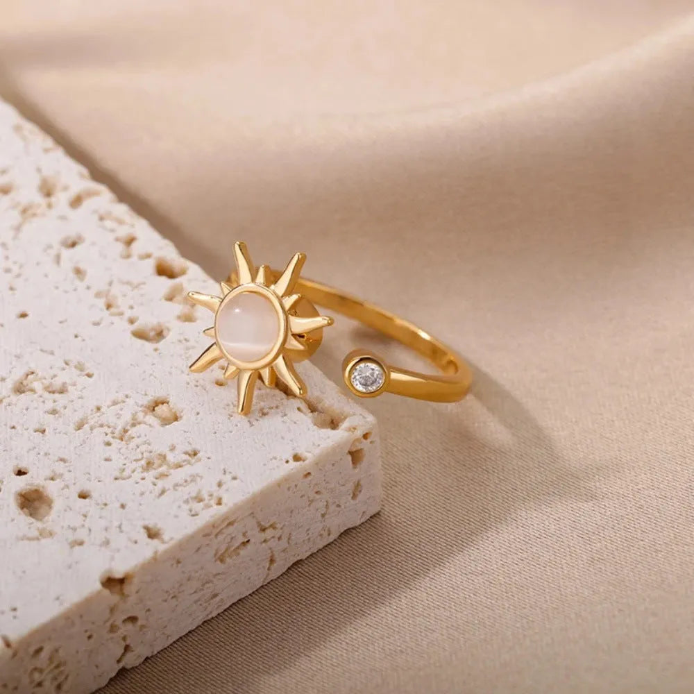 Adjustable copper ring with rotatable element in gold or platinum finish, simple geometric design