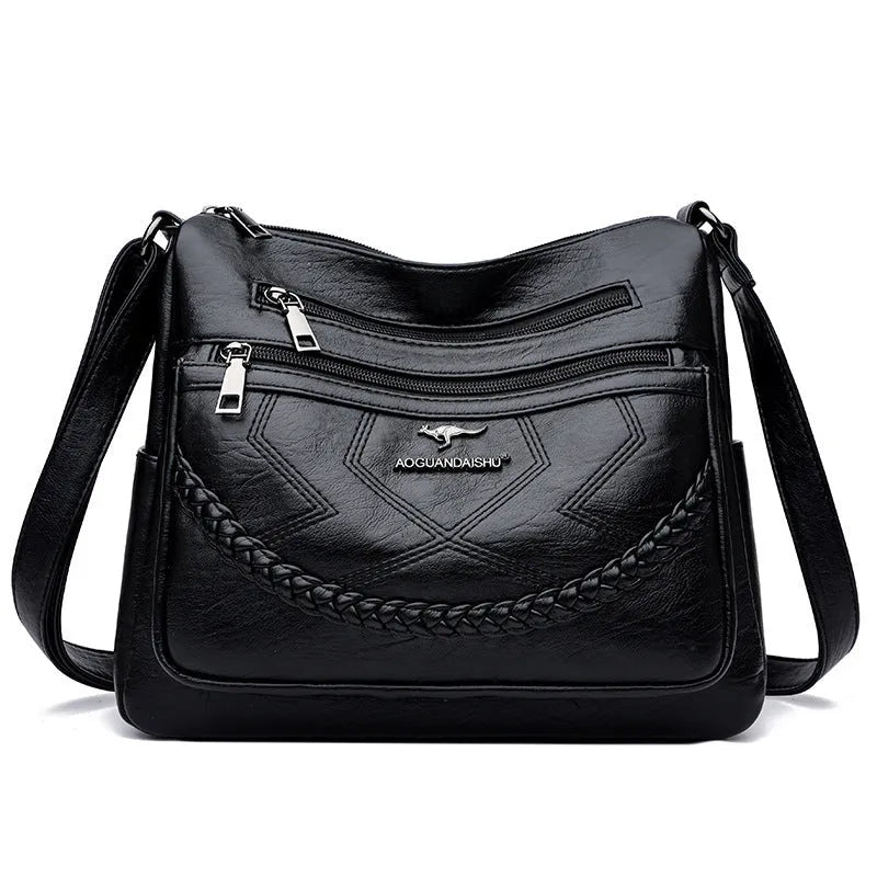 Soft PU leather shoulder bag in horizontal square shape, shown in one of four colours with crossbody strap