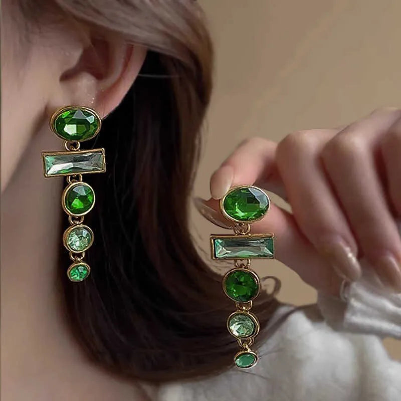A pair of green gradient geometric alloy earrings with zircon inlay and tassel details.