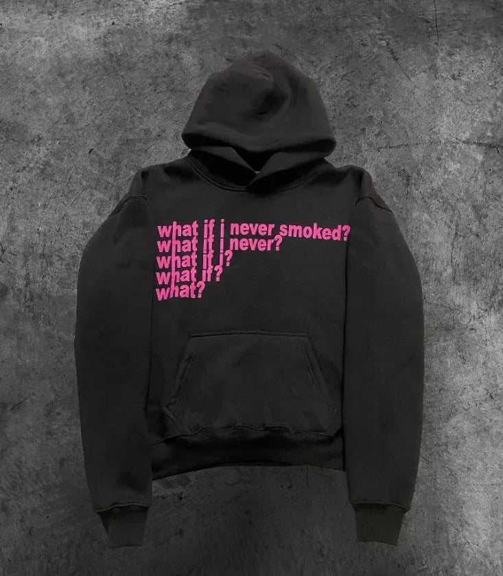 Man wearing a black heavyweight hooded sweater with a large white letter print design on the front.