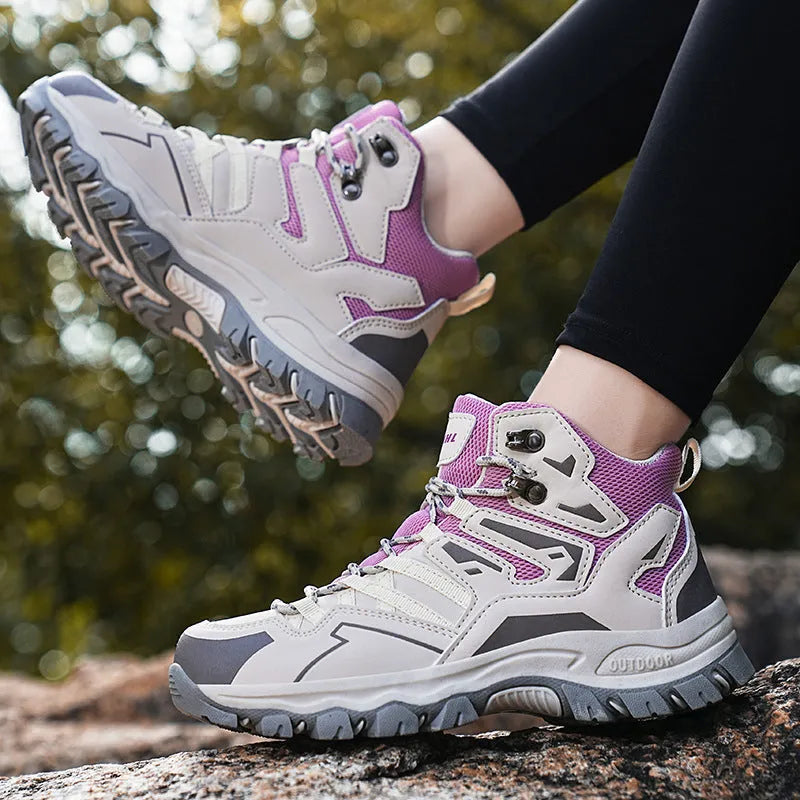 A pair of low-top hiking sneakers with a lace-up front, shown in a colour option like grey or purple.