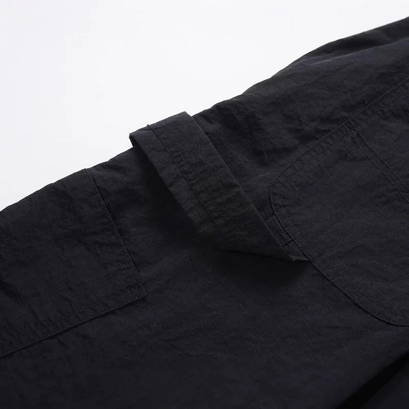 Black paratrooper pants with elastic drawstring waist and three-dimensional baggy cut