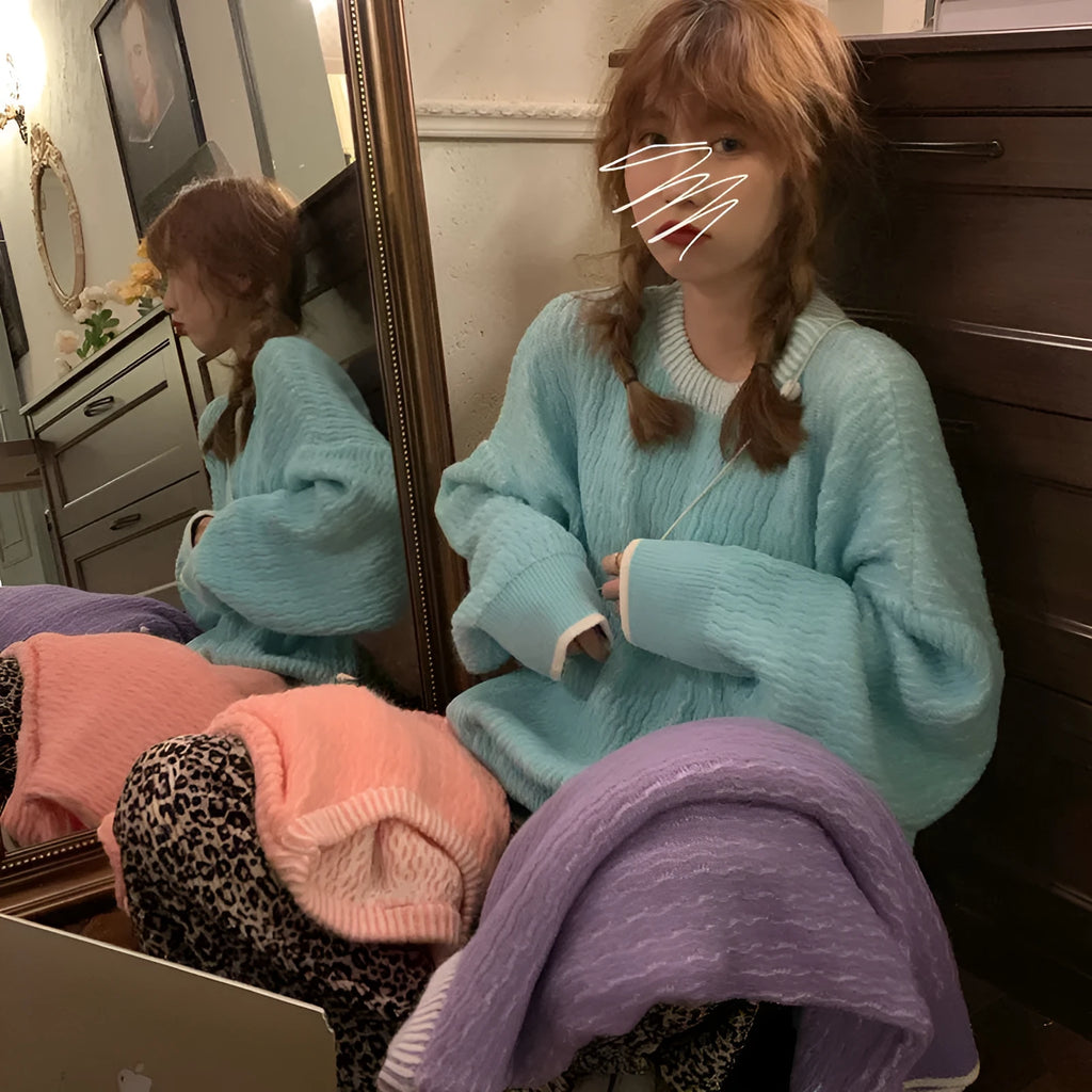 Women's loose blue retro pullover sweater with regular sleeves on a hanger