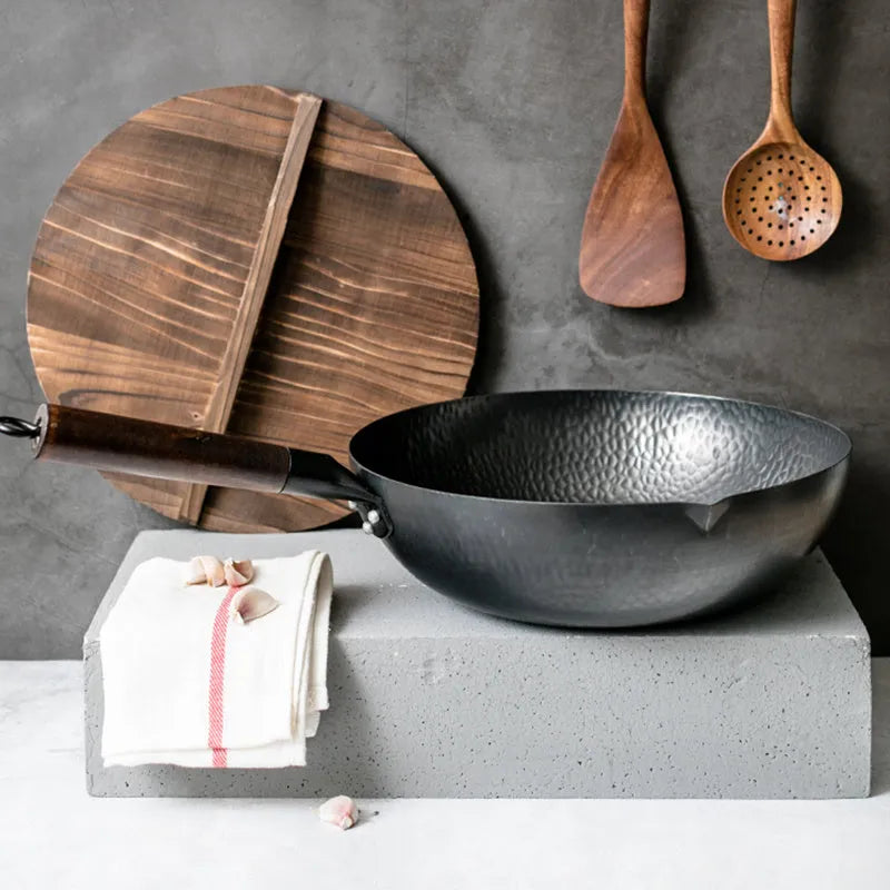 Traditional black iron wok with wooden handle showing 40cm diameter and flat induction base