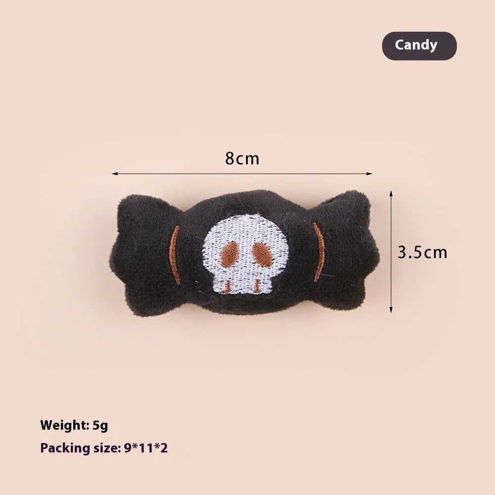 Small plush cat teaser toy with candy, eyes and skull attachments on lightweight handle