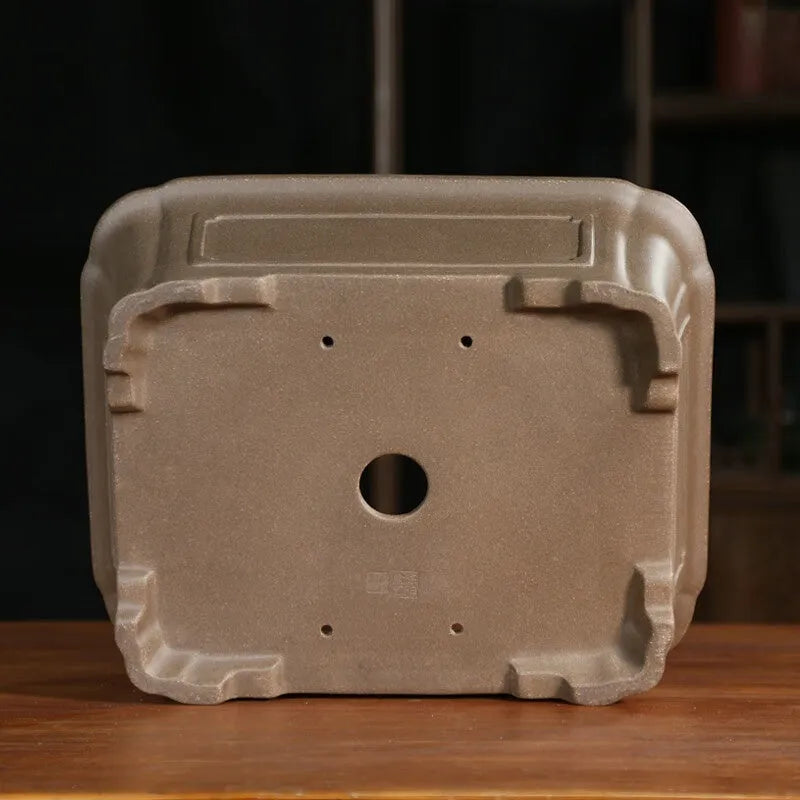 Antique-style rectangular purple sand planter with cut corners on a floor.