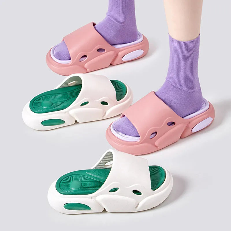Two-colour thick-soled EVA slippers for couples on a floor, showing pink and purple or black and white colour options.