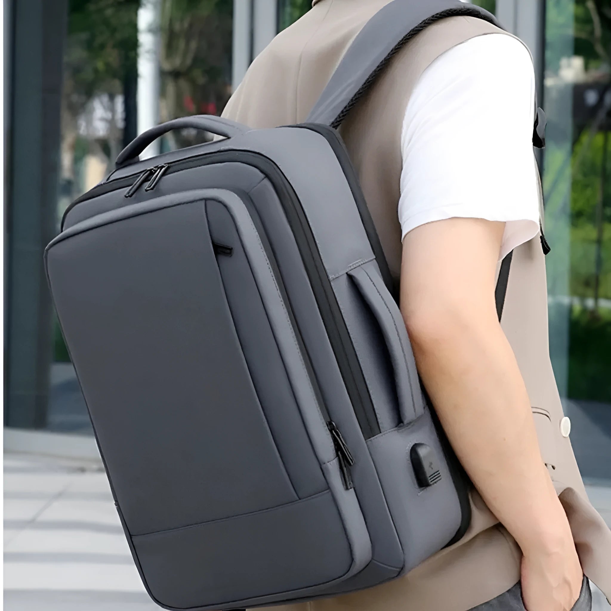 Large capacity waterproof backpack in black or grey Oxford cloth with curved shoulder strap and hand-carry handle