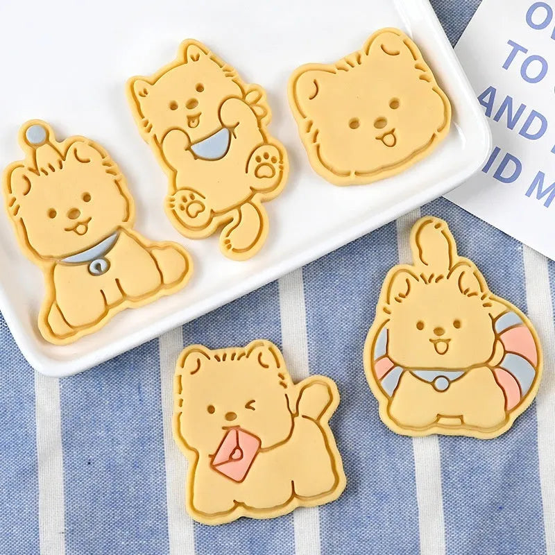 Three dimensional plastic biscuit mold showing puppy head and birthday hat designs
