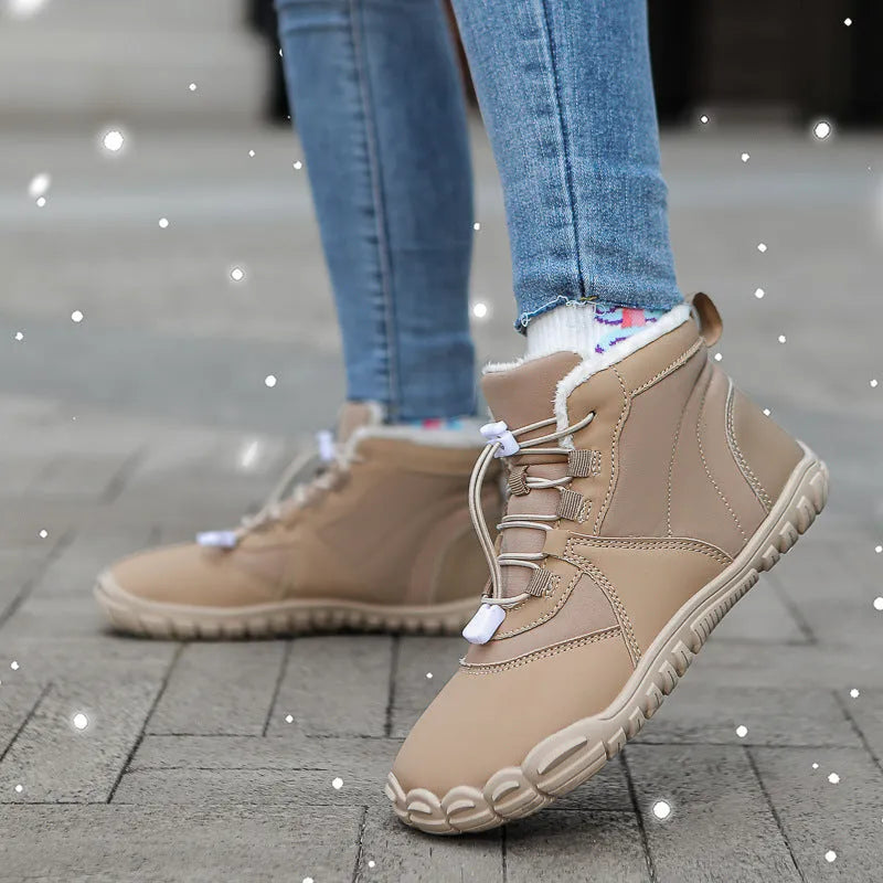 Unisex black waterproof snow boots with lace-up front and thick rubber sole on a snowy background.