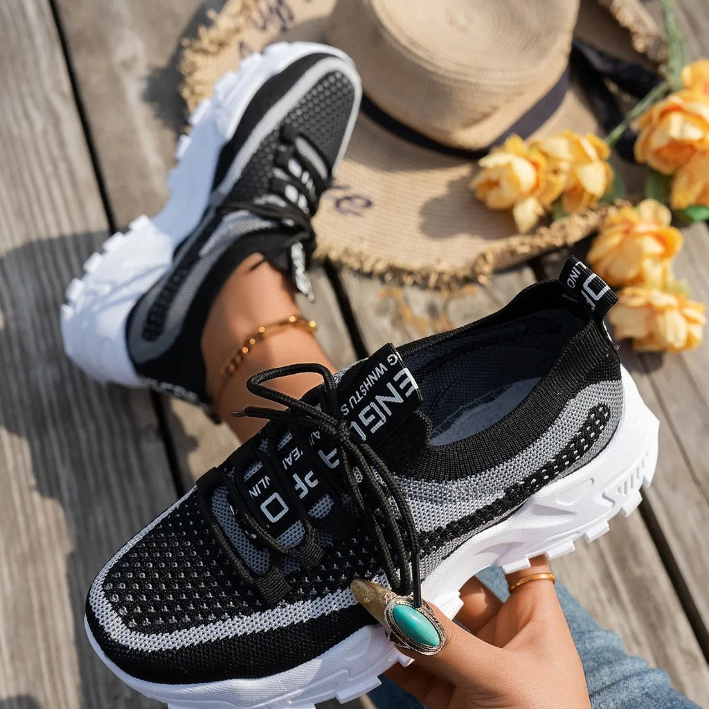 Women's Flyknit lace-up sneakers in a selected colour with a low rubber sole and round toe