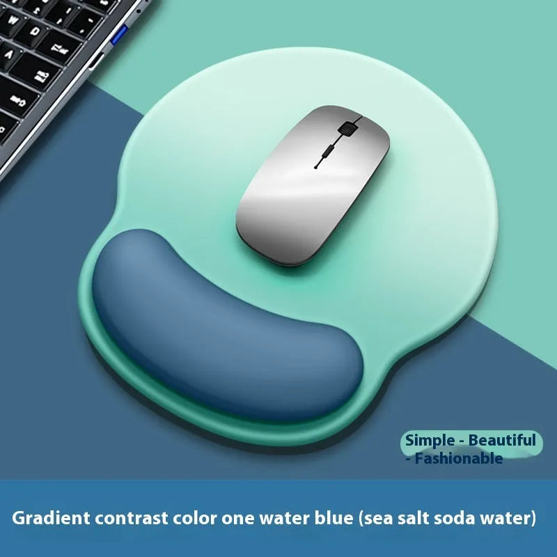 Silicone mouse mat with attached gel wrist support in a gradient blue colour on a desk.