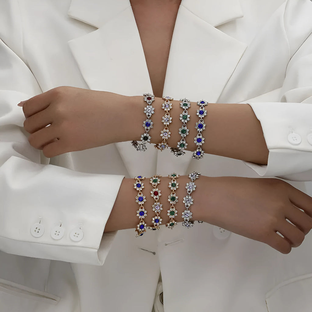 Electroplated zinc alloy bracelet with flower-shaped coloured gemstone charm in gold and silver colour variations