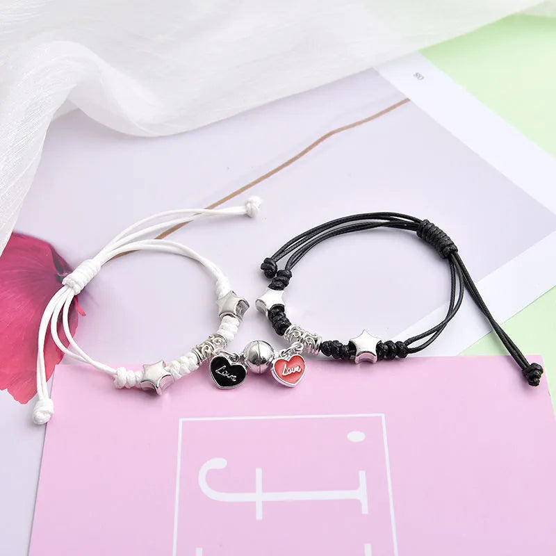 Pair of alloy suction bracelets with engraved symbol choices including crown, love lock, and clover.
