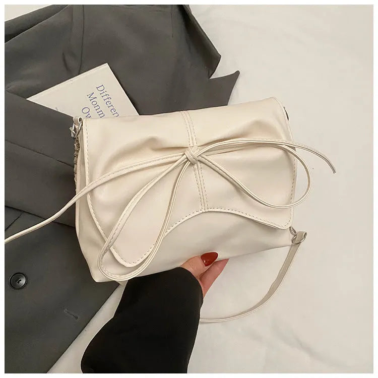 Women's underarm crossbody bag in horizontal square shape with sewing line details and phone pocket