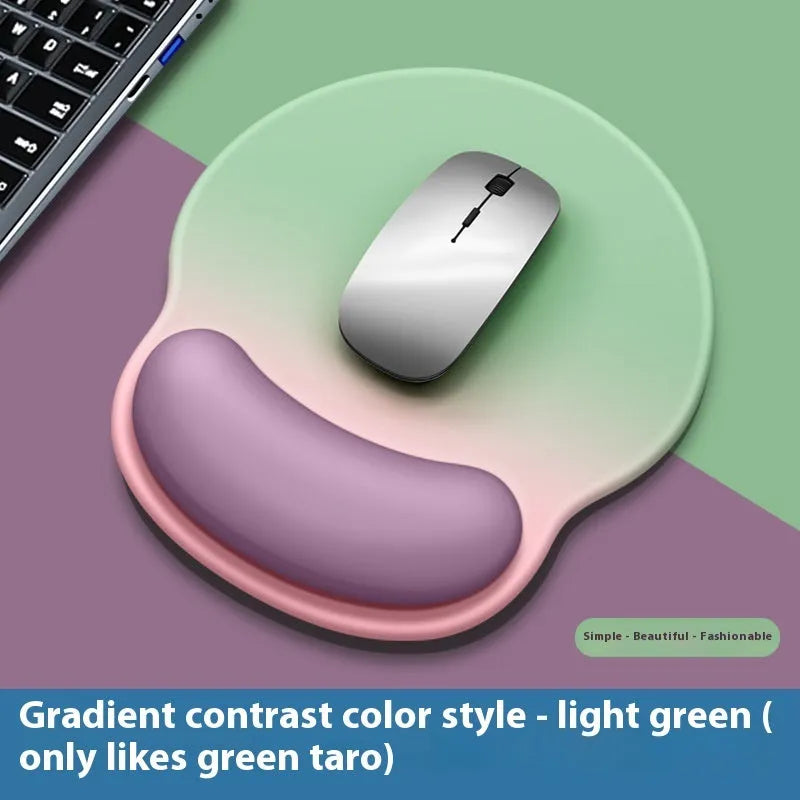 Silicone mouse mat with attached gel wrist support in a gradient blue colour on a desk.