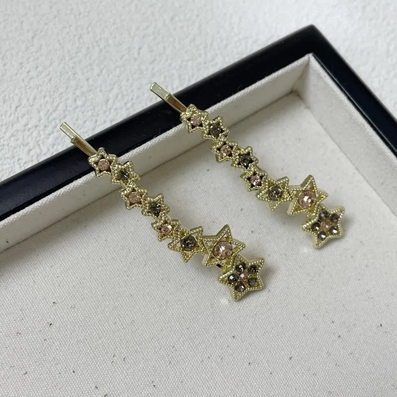 Gold alloy hair barrette with rhinestones and a star charm, shown as a side clip for bangs.