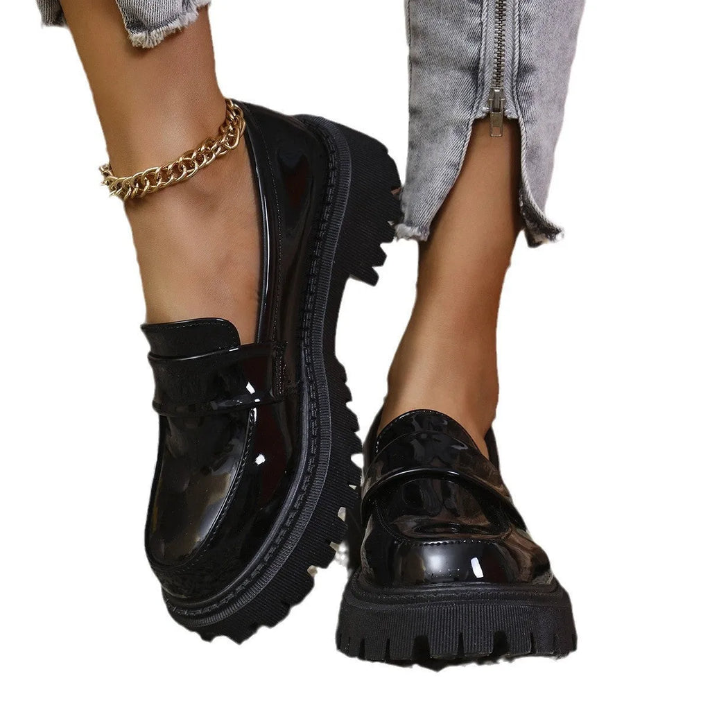Plus size black slip-on loafers with a chunky platform heel and thick rubber sole.