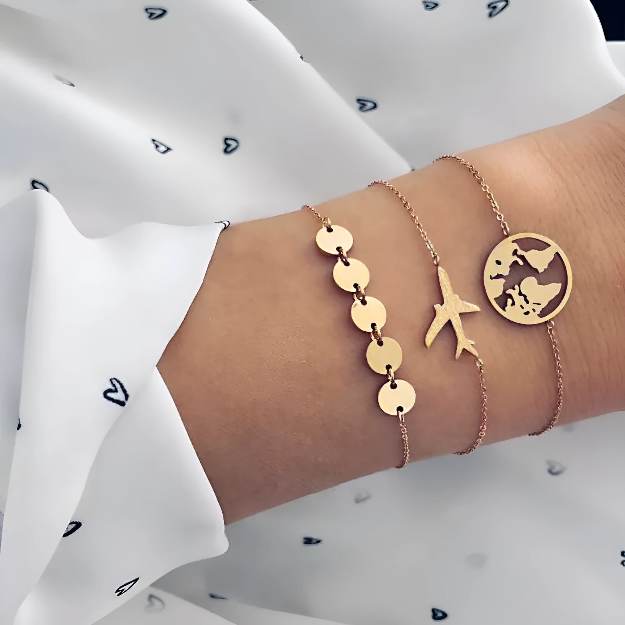 Three Bohemian-style bracelets with aircraft map charms and heart shapes in electroplated alloy