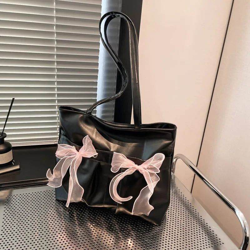 College style large capacity black tote bag with bow detail and double shoulder straps.