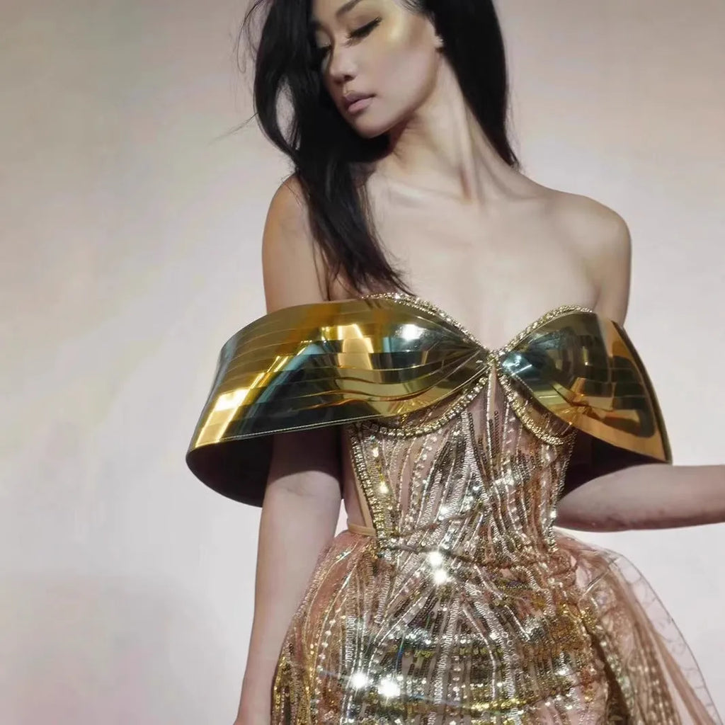 Gold sequined strapless evening dress with high-leg split and tulle underlay