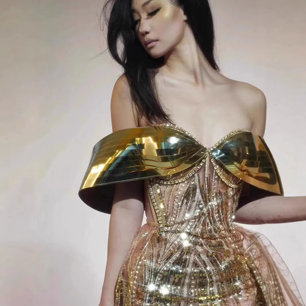Gold sequined strapless evening dress with high-leg split and tulle underlay