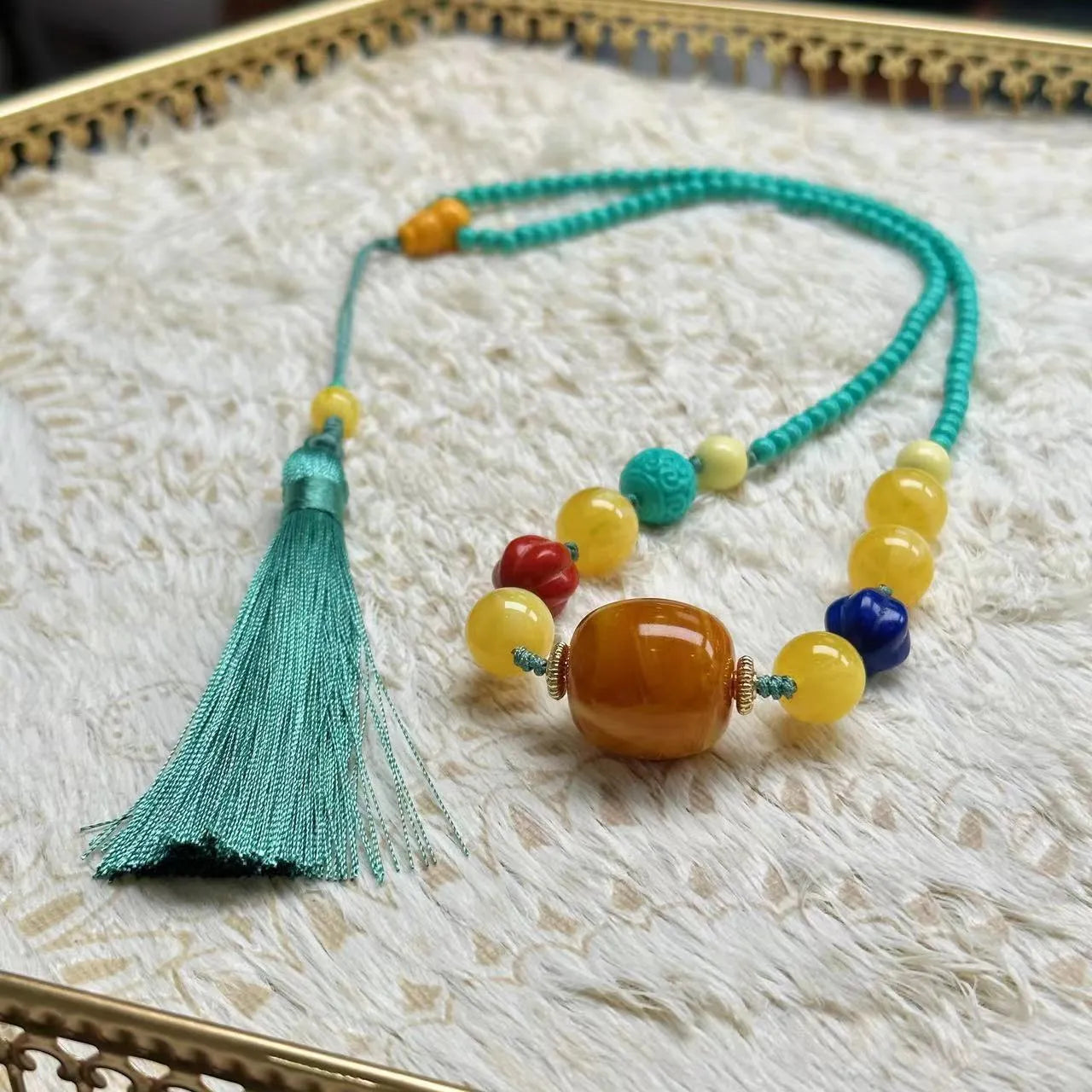 Turquoise lucky pendant necklace with hand-woven mesh flower design on ball bead chain