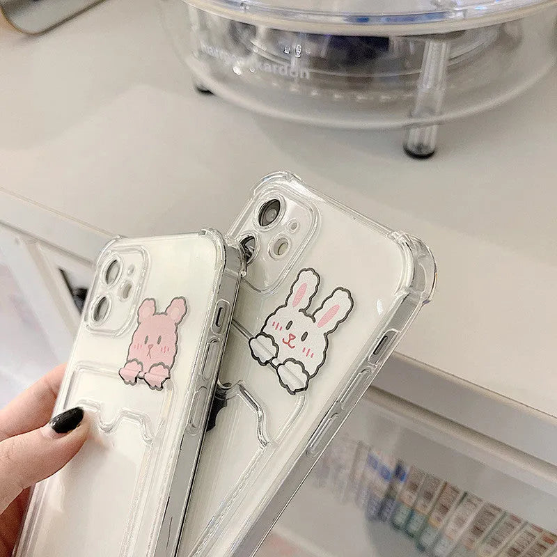 Clear cartoon design iPhone case with a card slot on the back, shown on a phone.